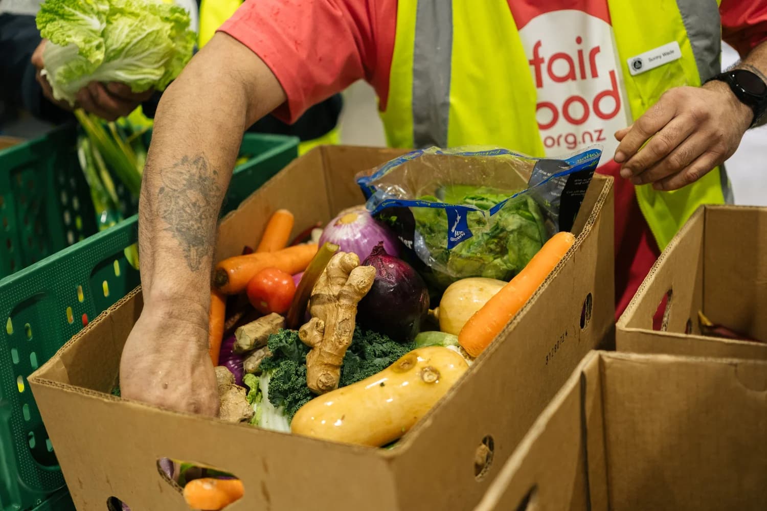 Volunteers packing kai boxes ready for whānau